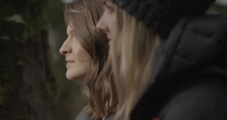Two women are sitting smiling