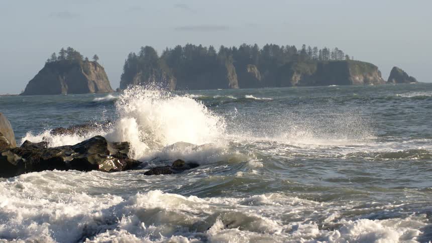 Ocean waves crash into rocks