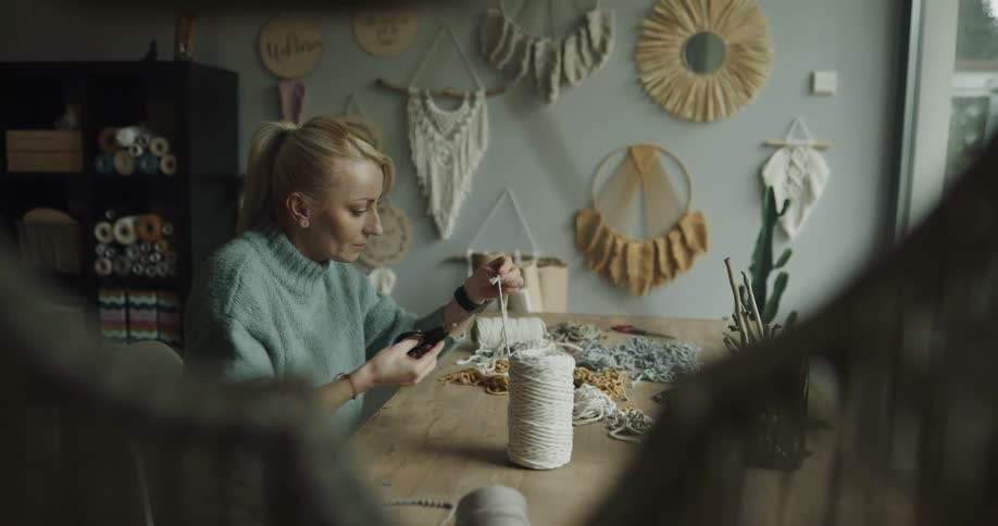 A woman is sorting thread in the room