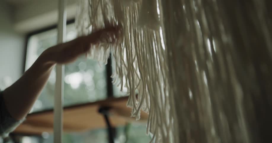 A person working with some string in a studio