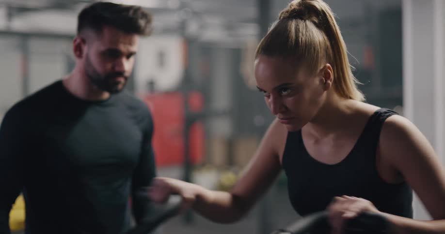 A man and woman are exercising indoors