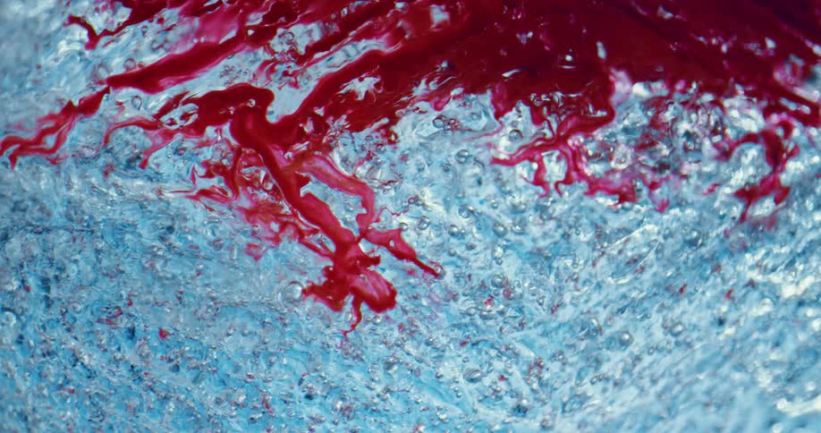Red liquid is poured over blue ice