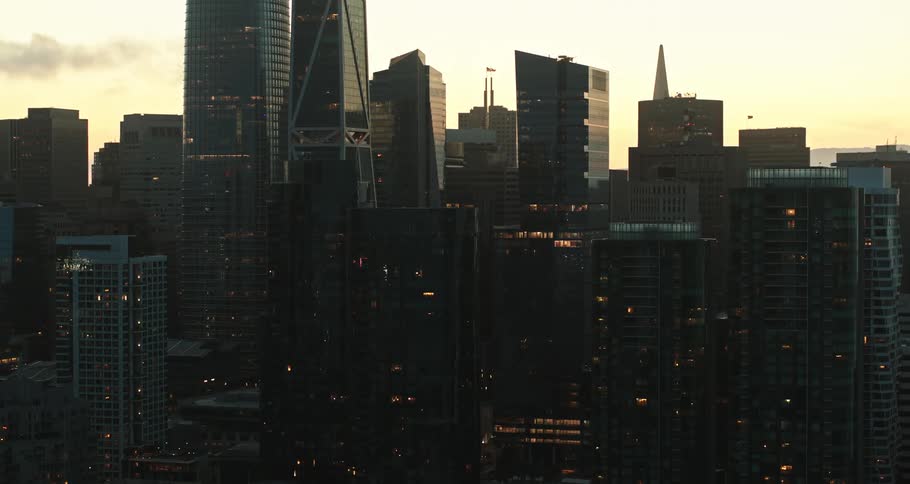 Lights are sporadically on in tall apartment buildings and office buildings downtown at dusk