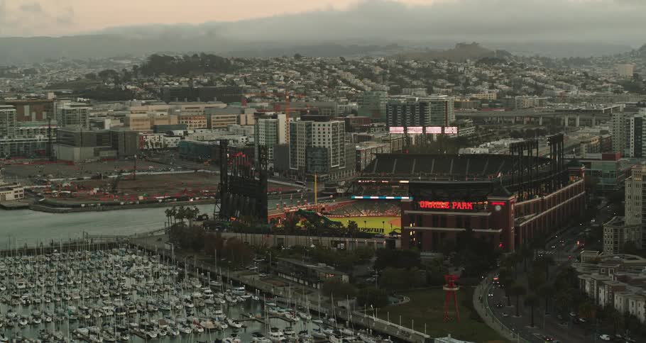 Aerial view of football stadium next to sea with many boats