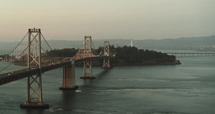 Cars traveling over a large bridge in the daytime