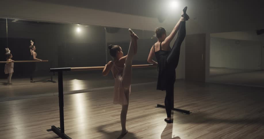 A woman and a child practice ballet