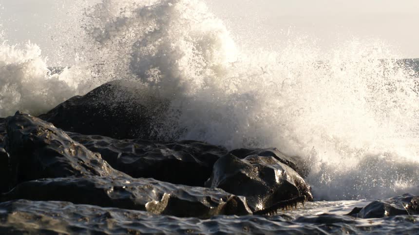 Ocean waves crash into a rocky shore