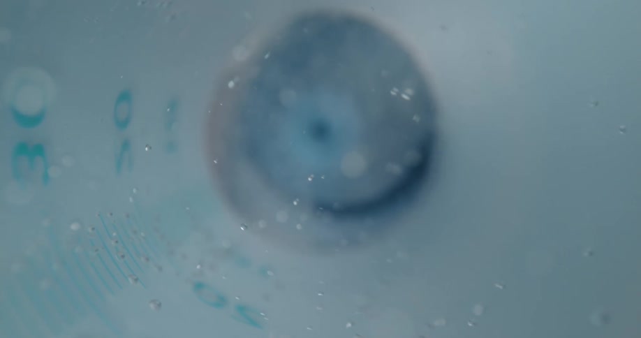 Liquid and bubbles moving in a syringe with markings on the side