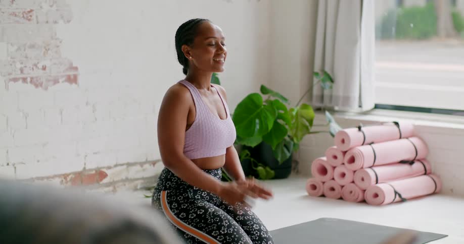 Young fit woman wearing sports clothing giving a yoga lesson online on a laptop