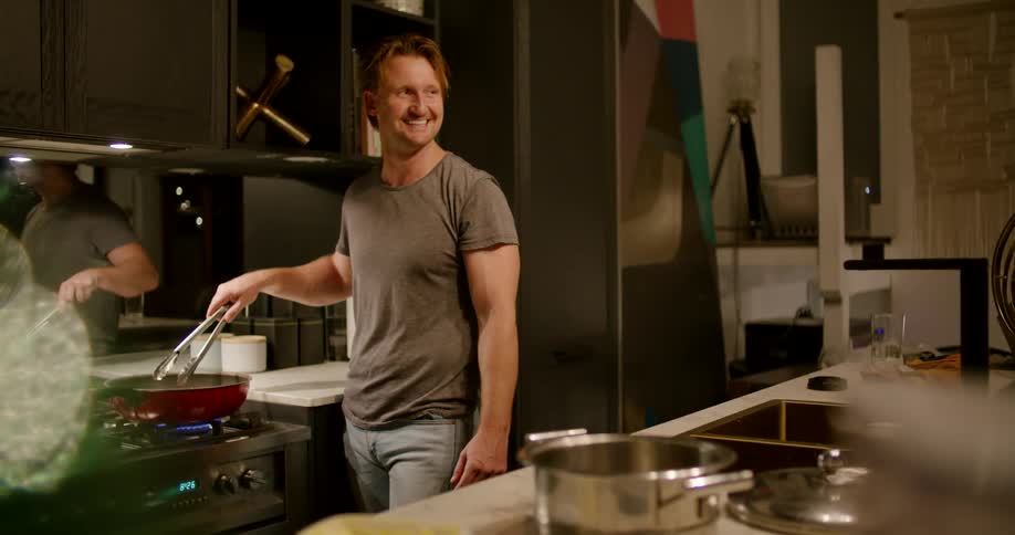 A man is cooking in his kitchen