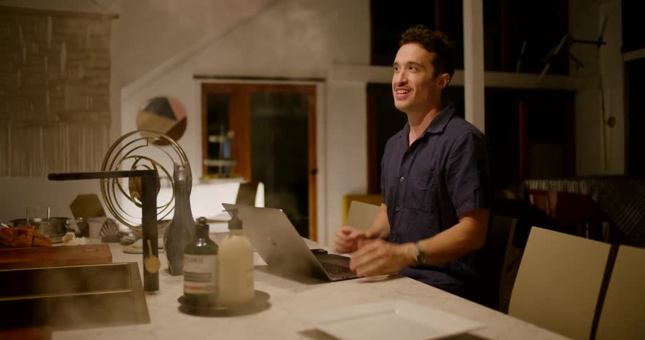 A man sitting with a laptop