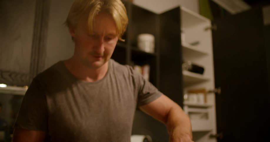 A man is cooking a meal inside of his house