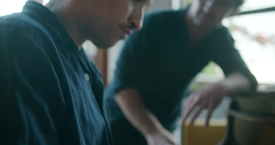A man giving piano lessons to a student at home