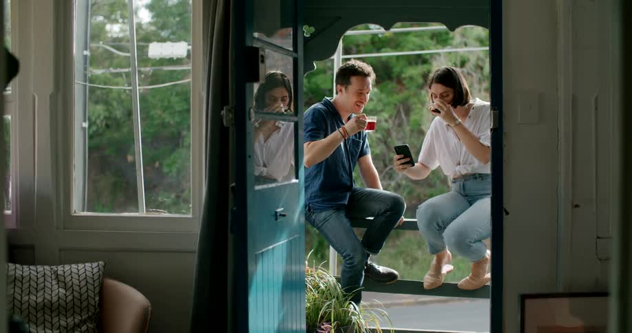 A man and woman sitting outside by a road