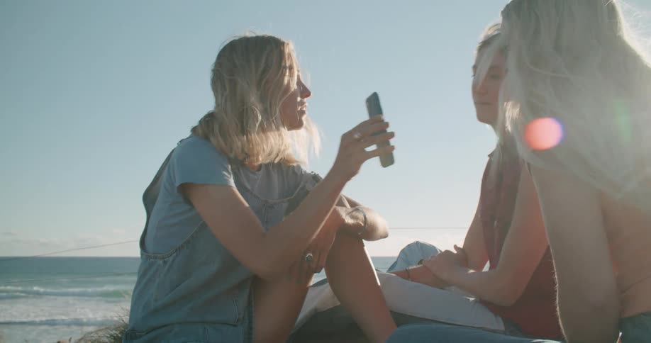 Three women looking at a smart phone