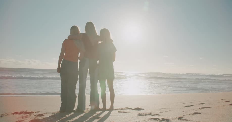 A woman puts her arms around her friends shoulders