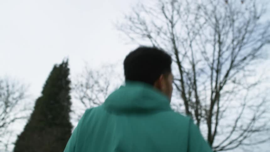 A man jogging down a sidewalk