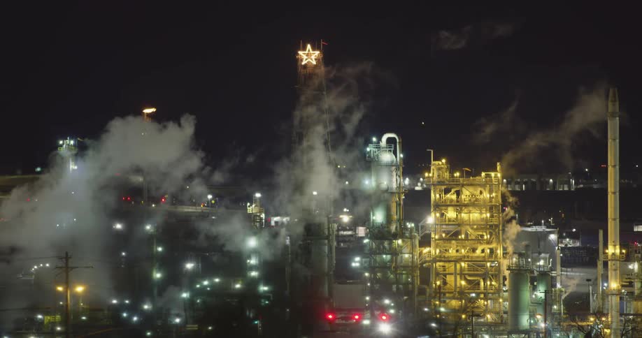 Smoke moves over the factory at night