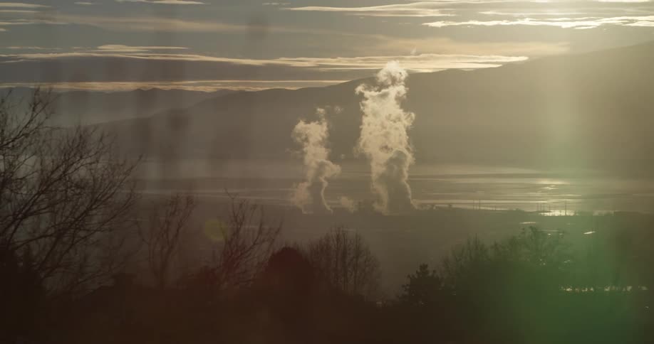 A wide shot of a landscape with smoke coming out
