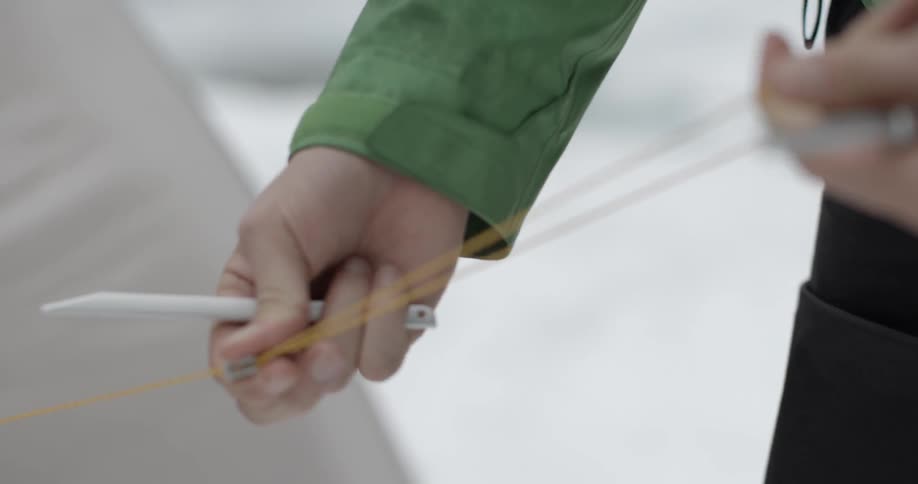 A woman is pulling a long yellow string