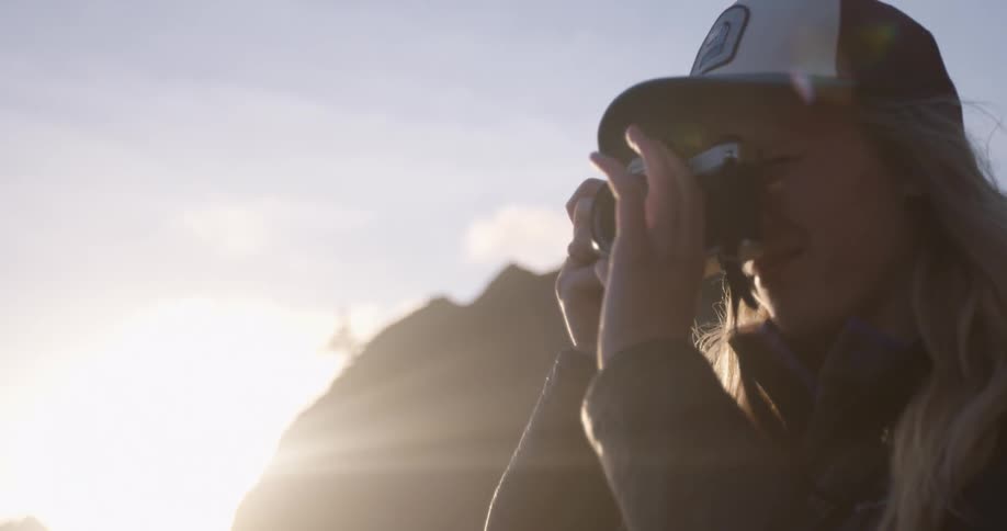 A woman adjusts the lens of her camera