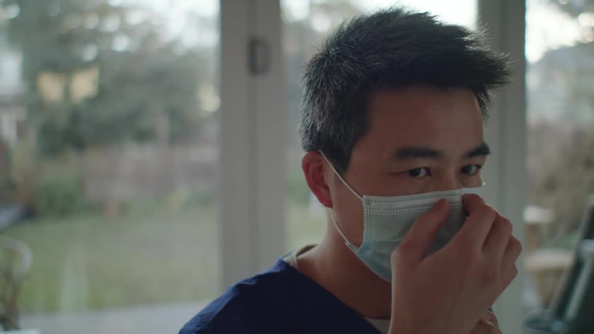 A man putting on a mask