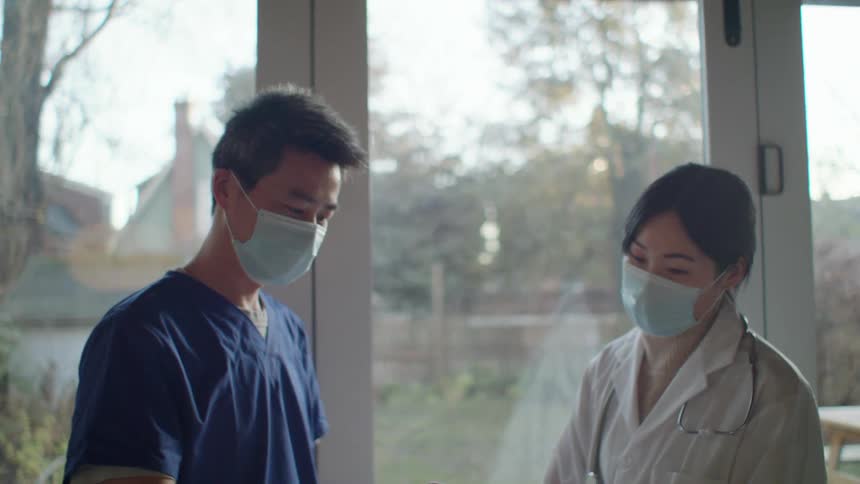 Two doctors talking to each other about a chart