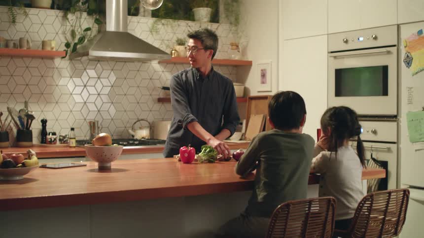 A family sitting in a kitchen