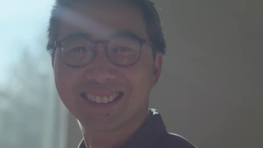 A man smiling in a sunny room