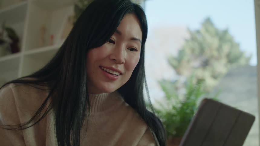 A woman talking to a tablet