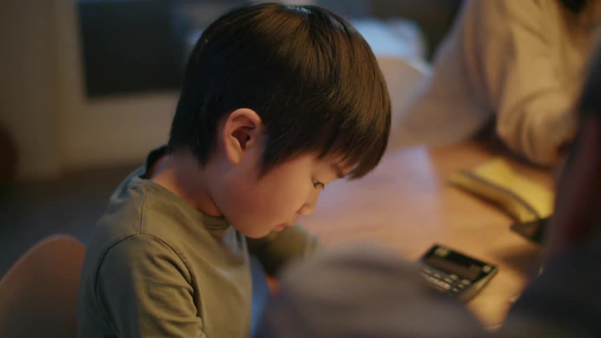 A child working on homework at a table