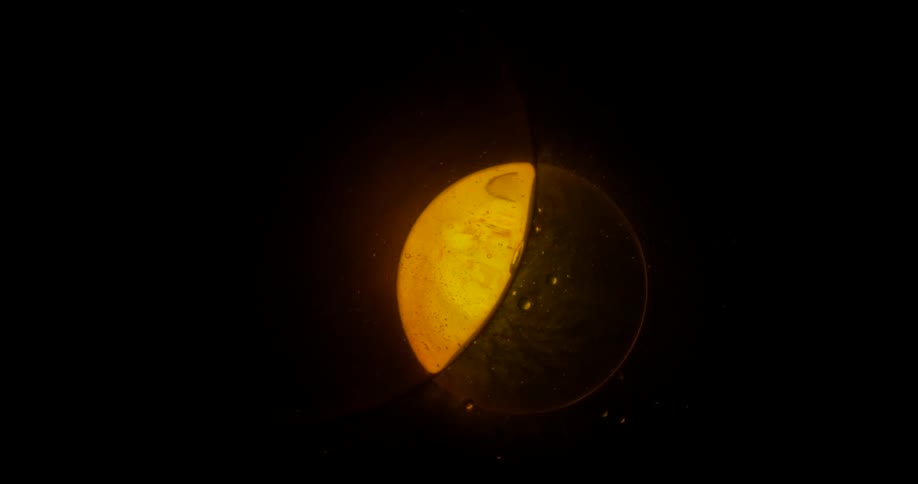Black yellow and brown colors that look like a planet