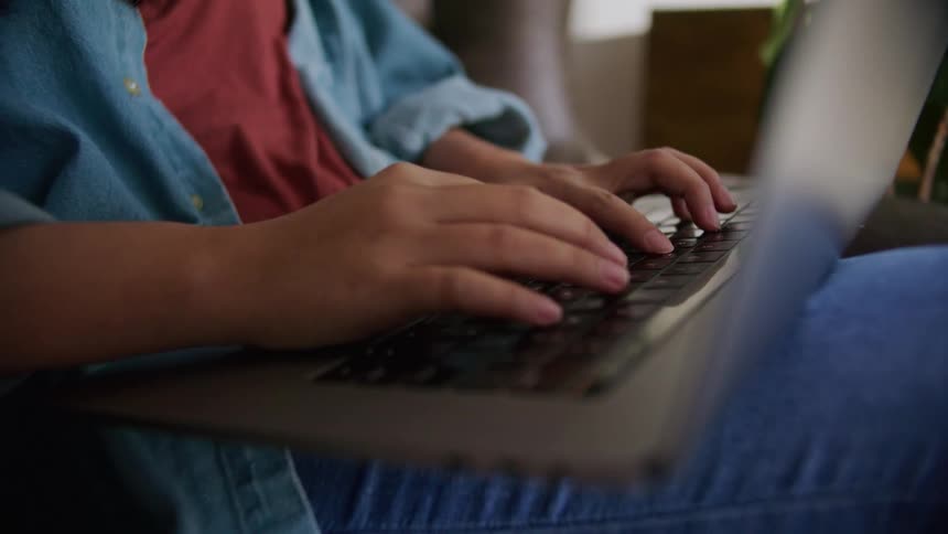 A person typing on a laptop