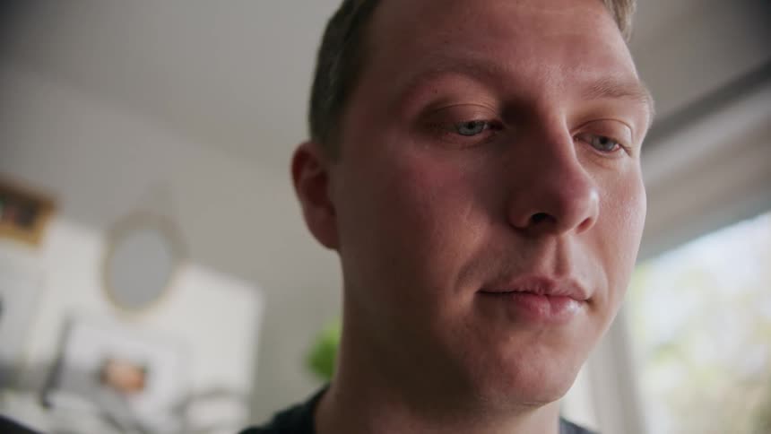 A man is standing in a room indoors