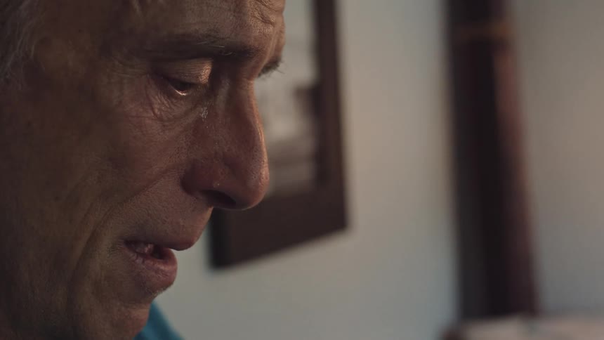 Close up of a man at home crying