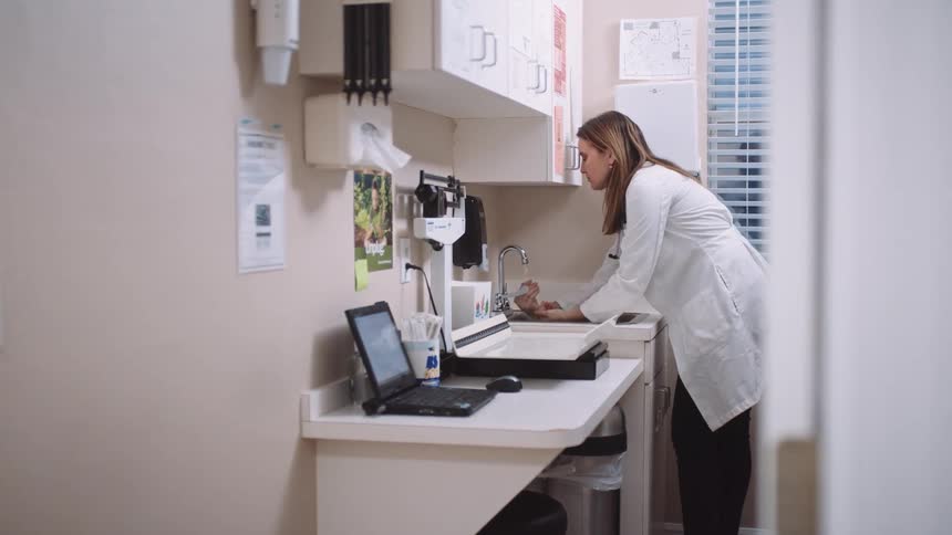 A doctor is washing her hands at the clinic