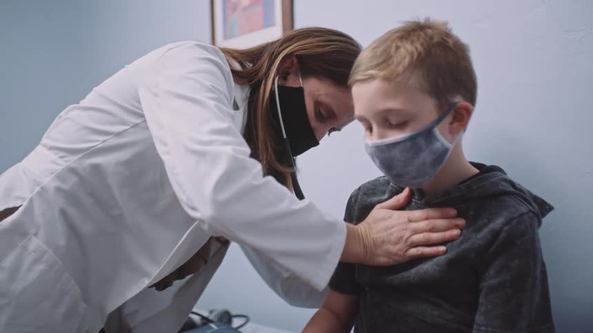 A child is getting a check up at the doctors office