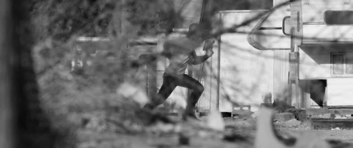 A man running with a gun in his hand