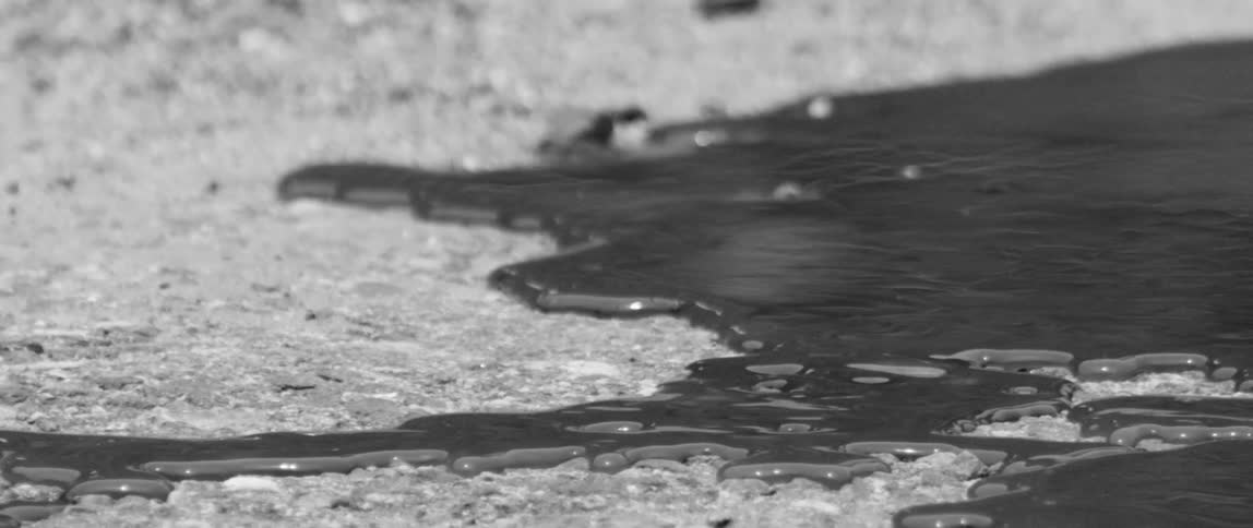 Dark liquid slowly coming ashore