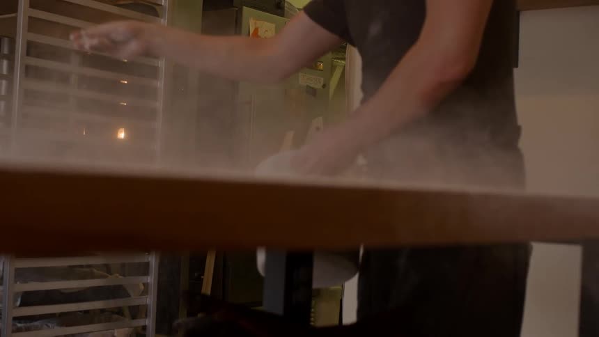 Person flouring a wooden table