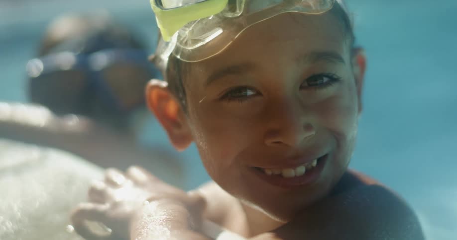 Children sit by the side inside the pool