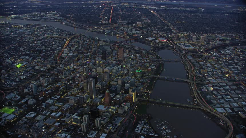 Medium wide panning aerial shot of blue hour magic in downtown Portland Oregon showing off the many bridges that span the Willamette River