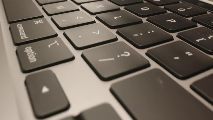 A woman pushes a key on a laptop