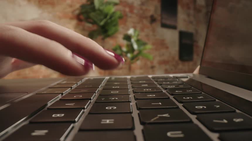 A woman typing on a laptop
