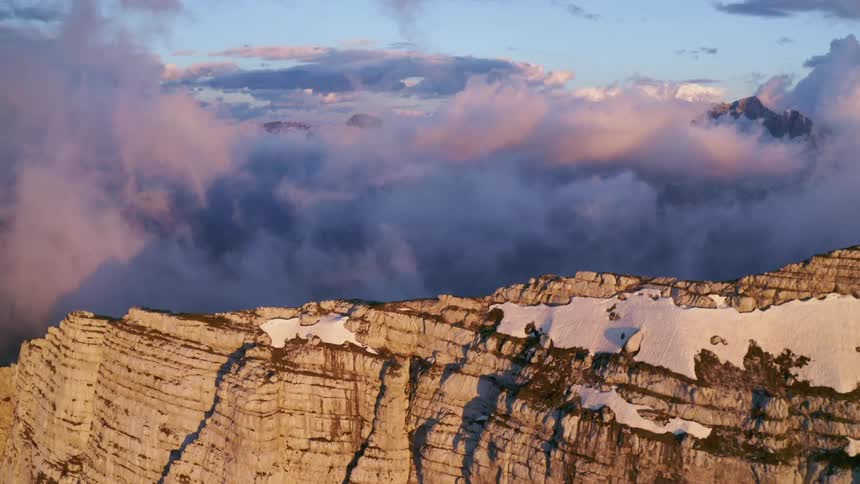 Clouds floating above a rocky mountain range in winter
