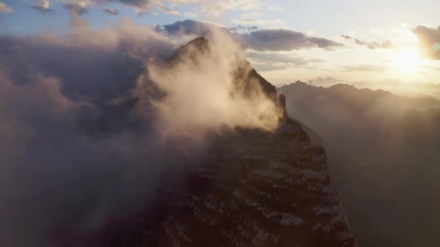 Flying around a mountain that has snow on it