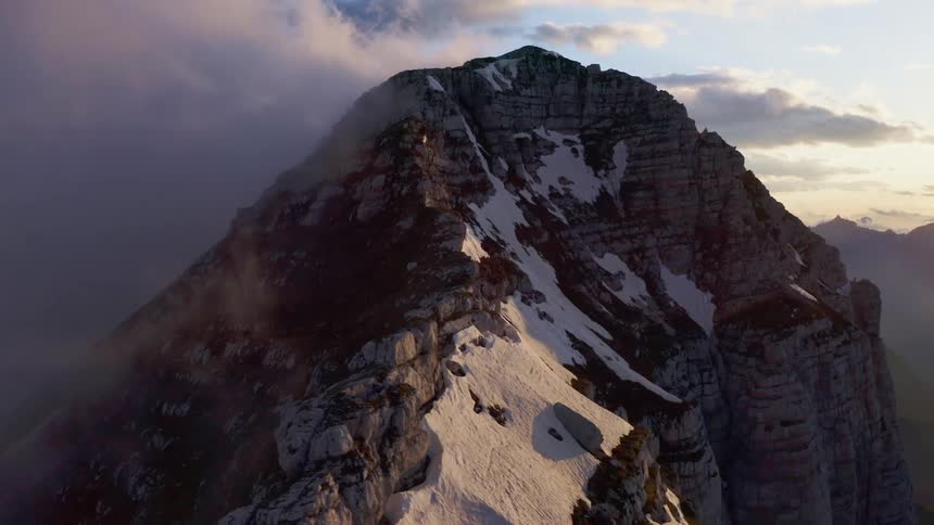 Aerial view of a mountain with snowy patches