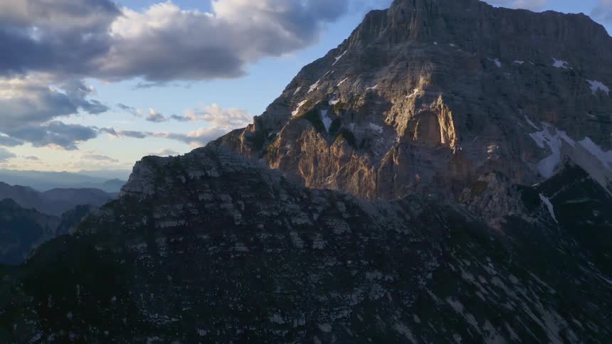 Aerial view of the snow covered peak on a mountain range at morning