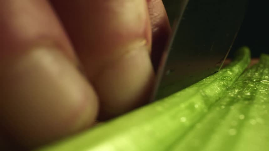 A person is cutting produce with a knife