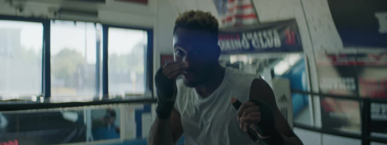 A man practicing boxing into the camera
